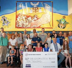 Veselka donating 10k to the Yankees children's charity with large check