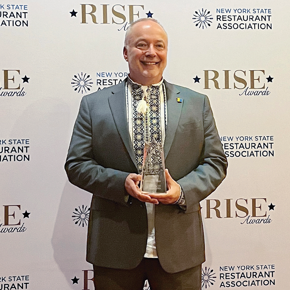 Jason posing with RISE award