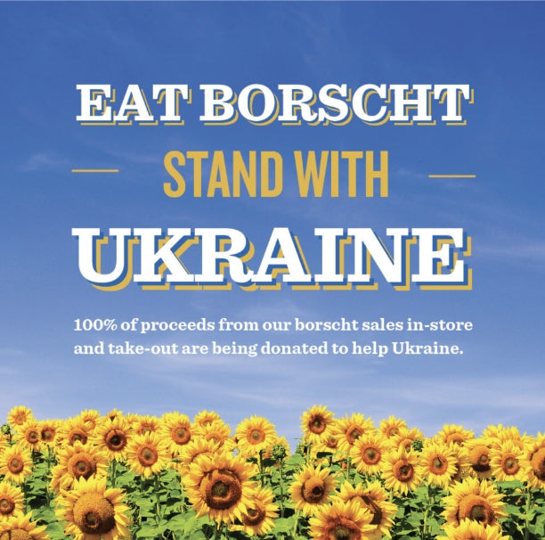 Eat Borscht stand with Ukraine graphic with a field of sunflowers at the bottom 