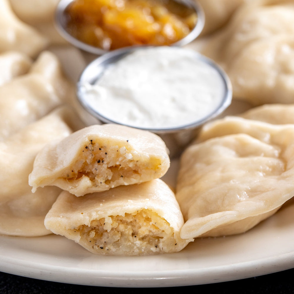  Potato pierogi cut open, boiled on a plate 