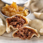 Short rib pierogi cut open, boiled on a plate 