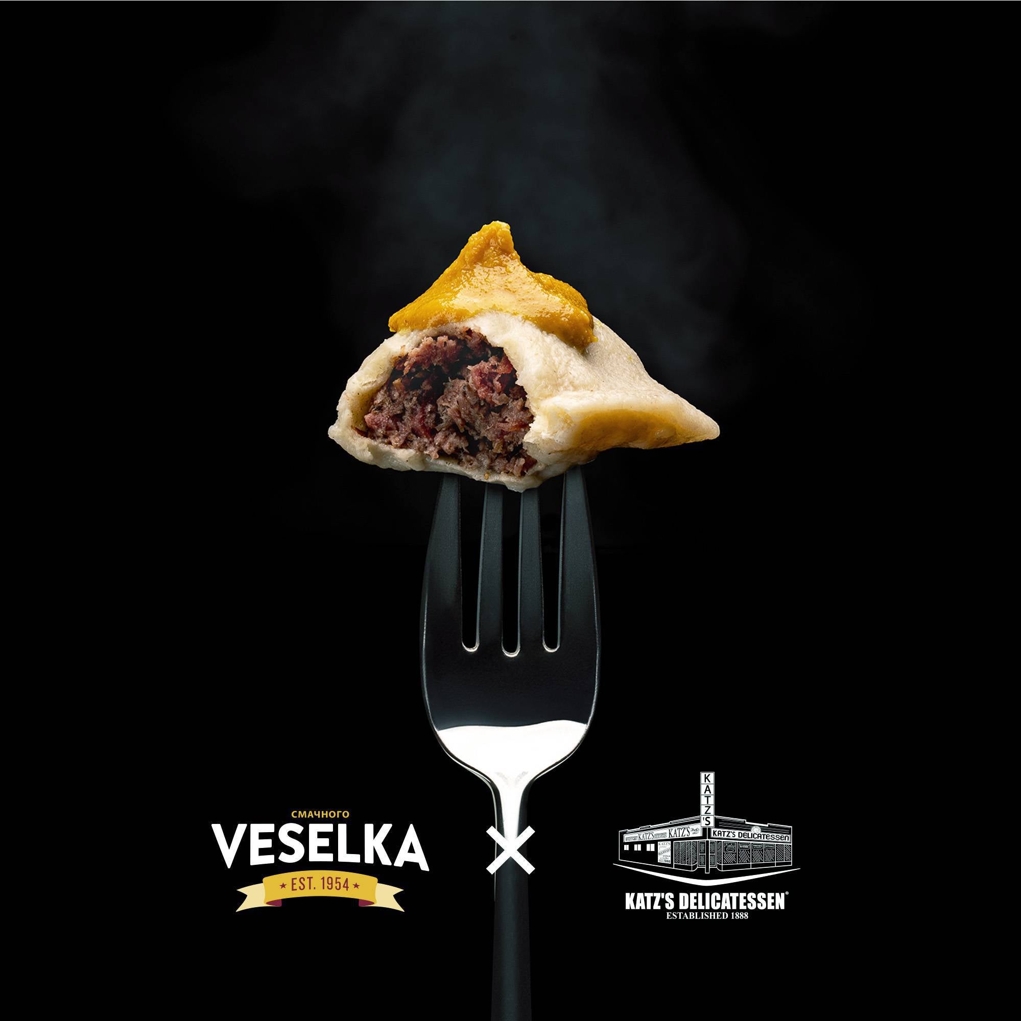 Pastrogi on a fork with Veselka and Katz's Deli logos