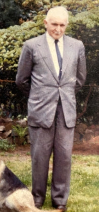 Original owner of Veselka in a suit outside in a green space