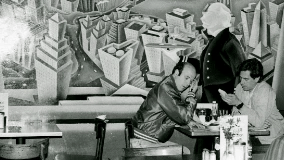 Vintage Veselka image of two diners sitting in a booth by a mural of the city, black and white