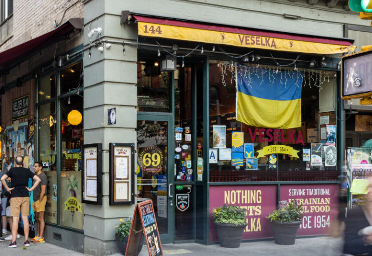 veselka modern, 2nd ave location with 69th anniversary logo in the door, customers walking around and in line 