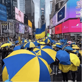 Blue and yellow Umbrellas at a rally in times square to support Ukriane during the invasion 