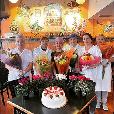 Pierogi ladies being celebrated with cake and flowers 