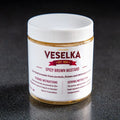 Spicy Brown mustard in a plastic jar with a label on the front 