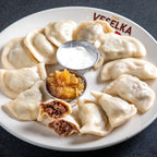 Short Rib Pierogi Veselka 2, Zoomed out, boiled, a dozen on the plate 