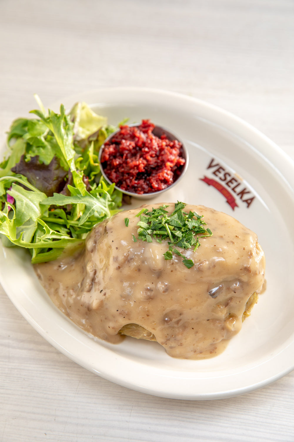 Stuffed Cabbage covered in gravy with small side salad 